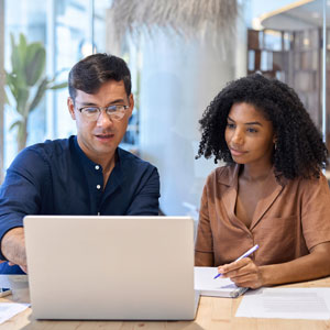 man and woman looking at laptop