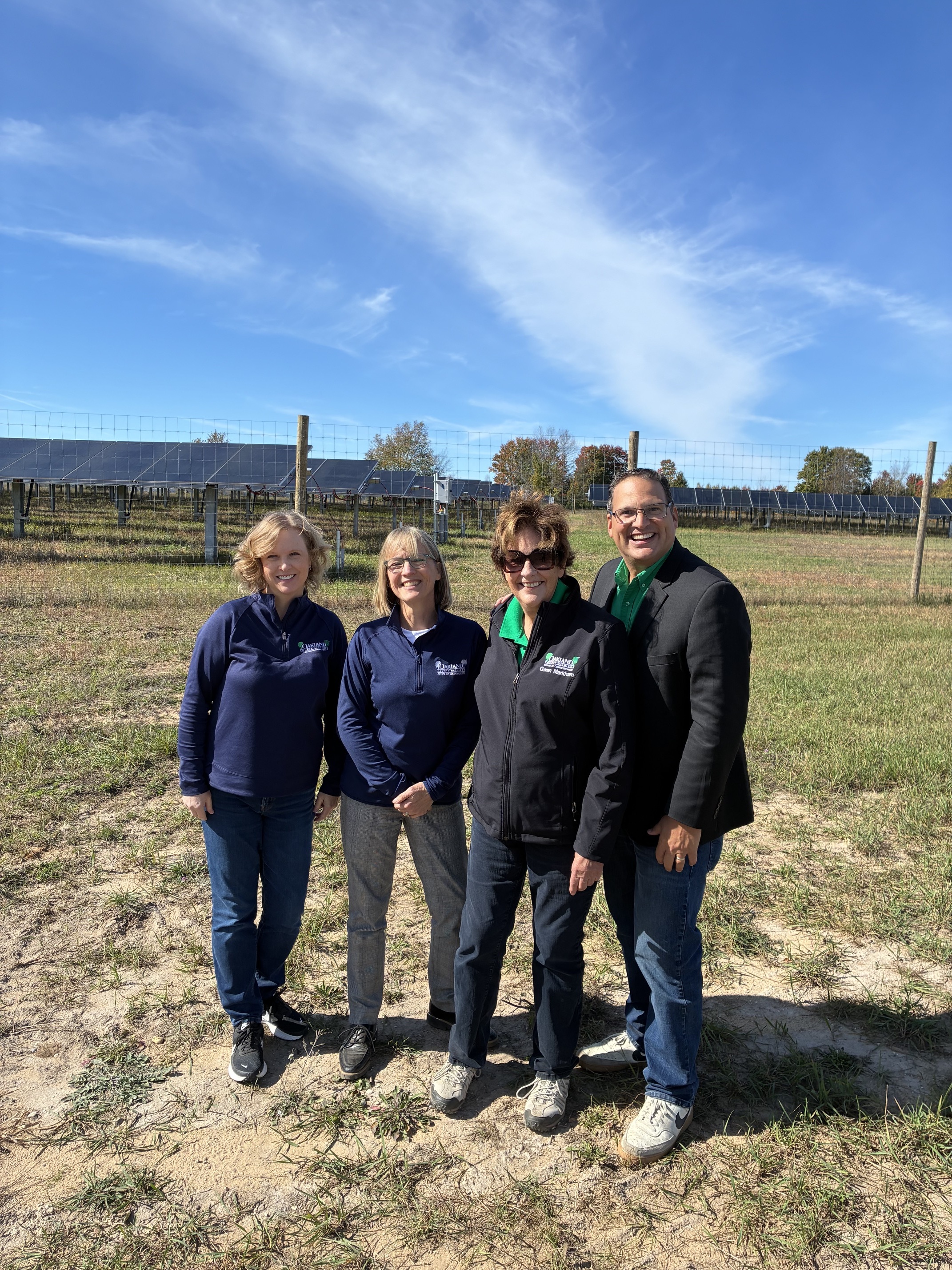 Board of Commissioners Chairman David T. Woodward of Royal Oak, Commissioner Gwen Markham of Novi and Chief Sustainability Officer Julie Lyons Bricker attended the grand opening of the Hart Solar Project.