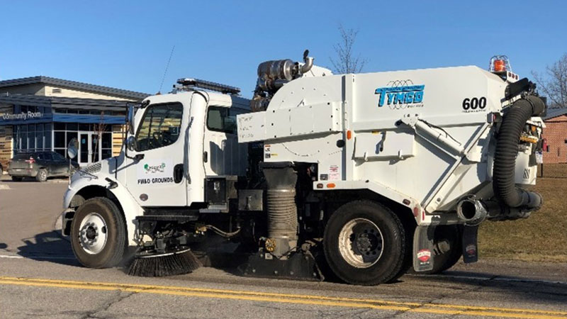 Oakland County street sweeper at a county facility parking lot.