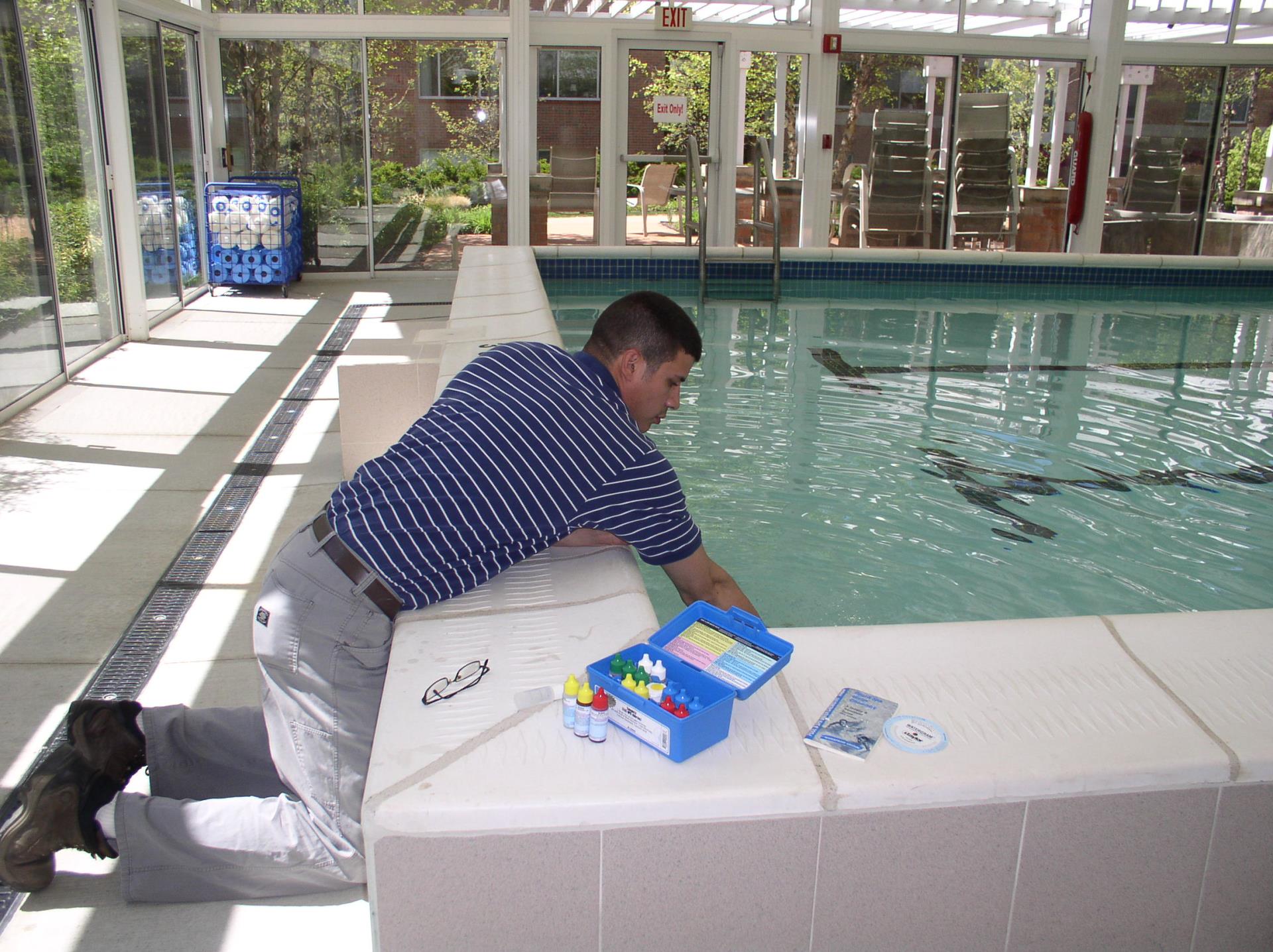 Public Health Sanitarian testing a swimming pool.