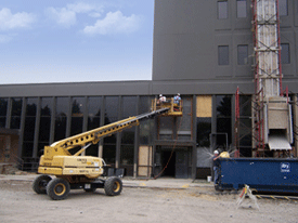 A bright yellow construction vehicle on a construction site.
