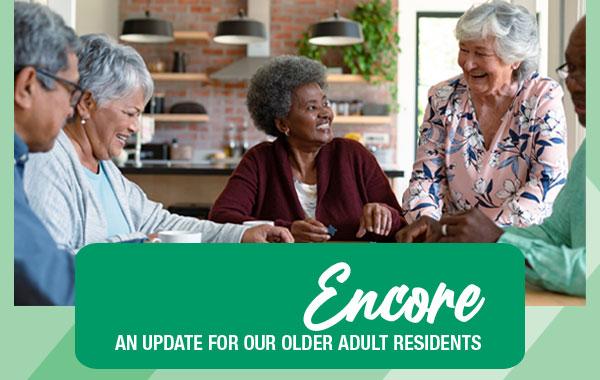 Group of diverse older adults sitting at a table putting puzzle pieces together.