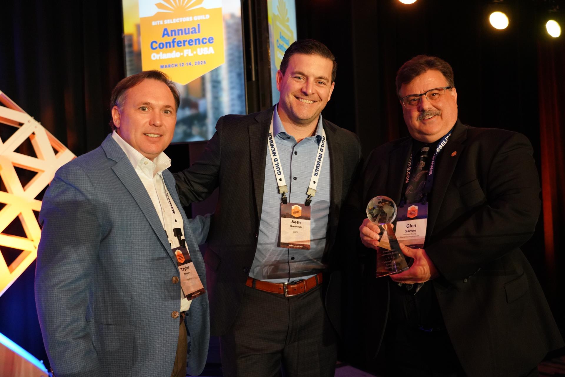 Three men hold award