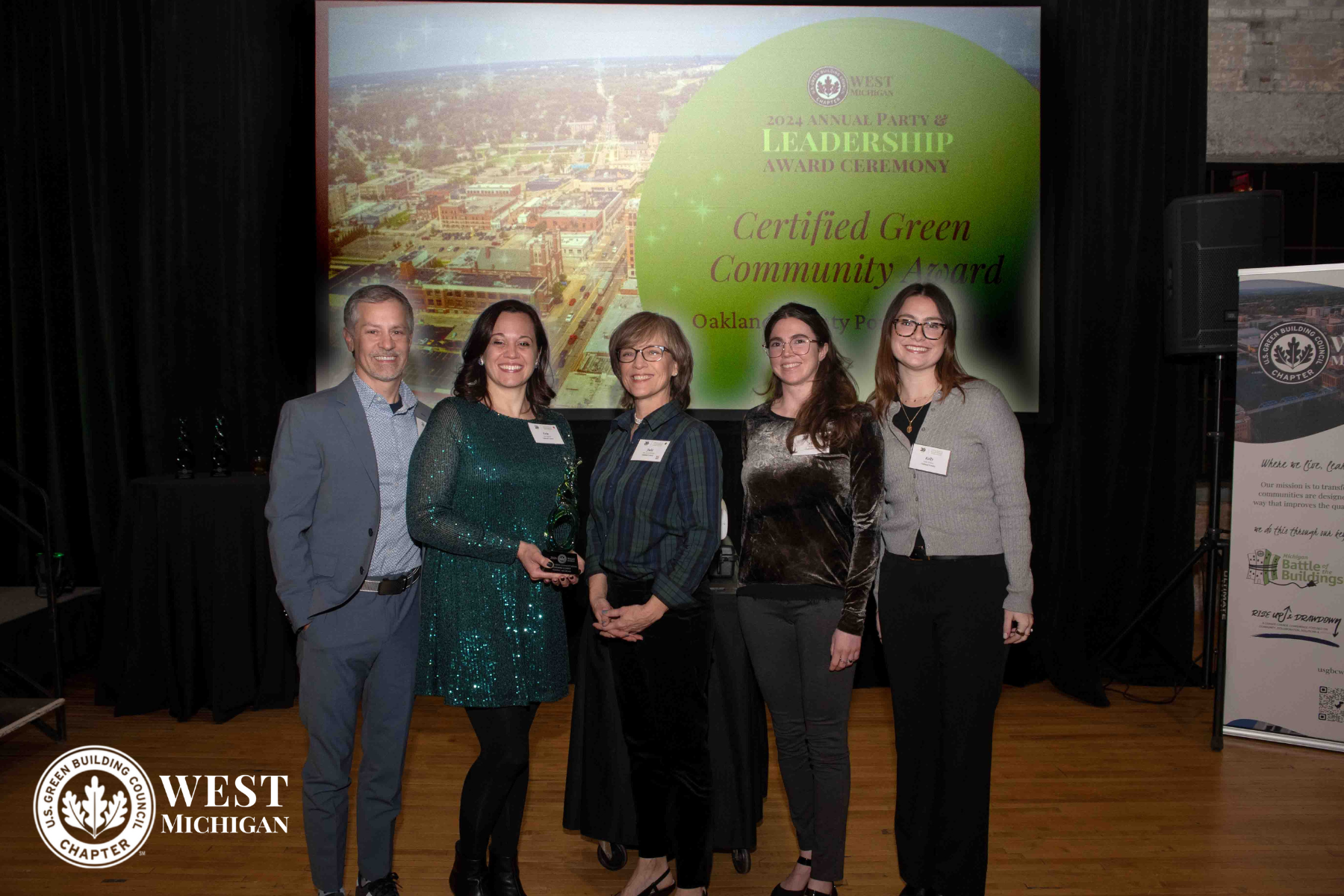 Five people pose with environmental sustainability award