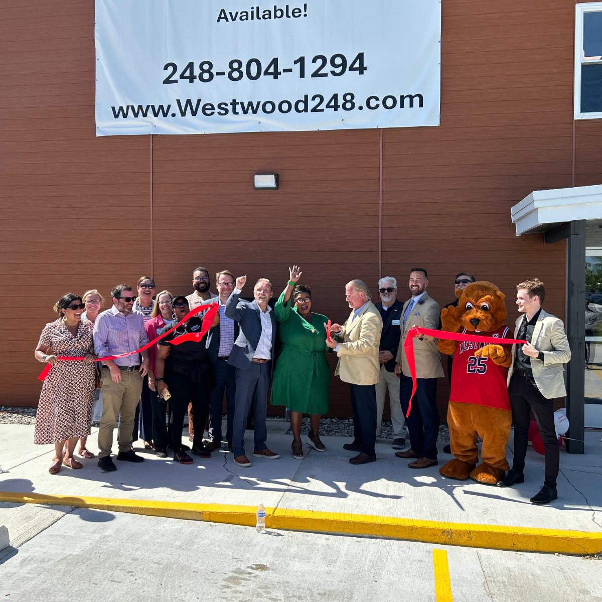 A group of people at a ribbon cutting event