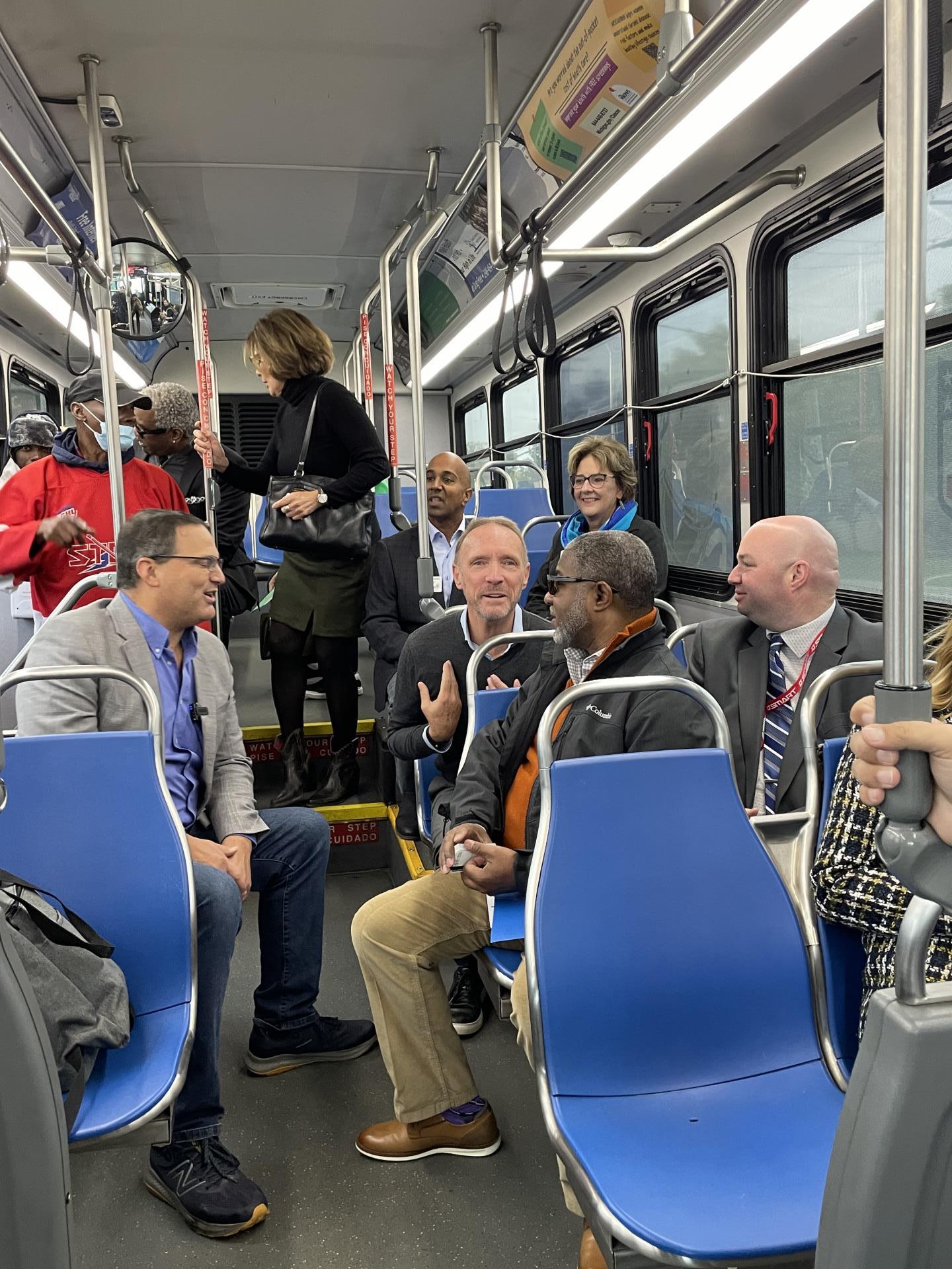 Oakland County Executive Coulter speaks with Oakland County Board of Commissioners Chairman David T. Woodward SMART Vice President of External Affairs Bernard Parker III and SMART Vice President of Paratransit and On-Demand Services Daniel Whitehouse.