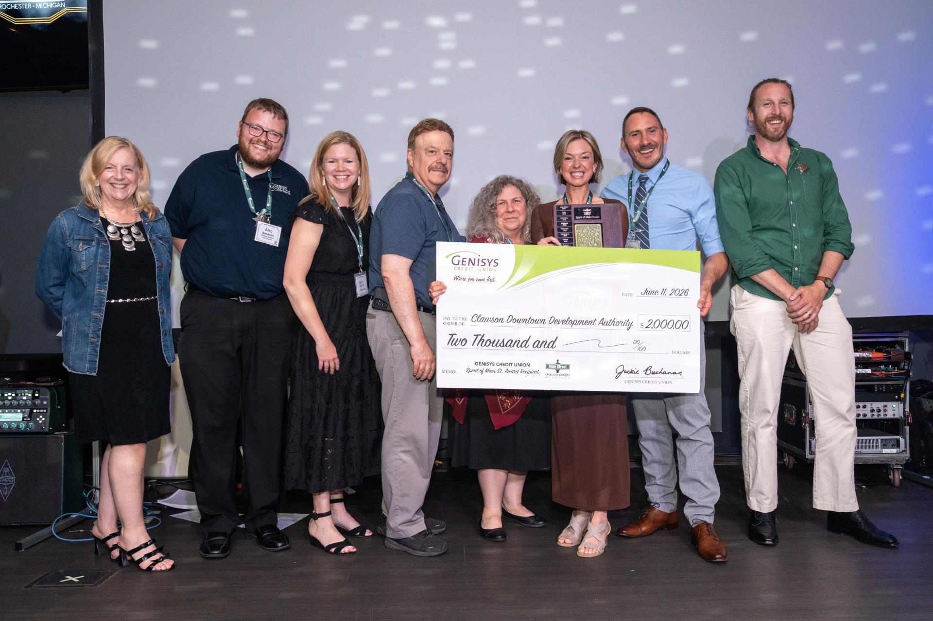 Clawson team that won the “Spirit of Main Street” Award for their video “Levels Up.” Theresa Doan representing award sponsor of $2,000 from Genisys Credit Union (far left).