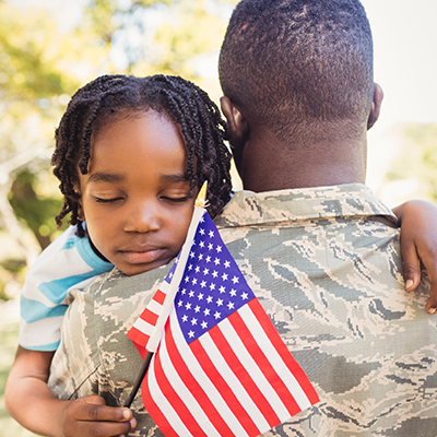 Veteran hugging his child